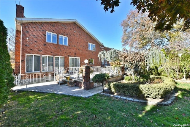 rear view of house with a yard