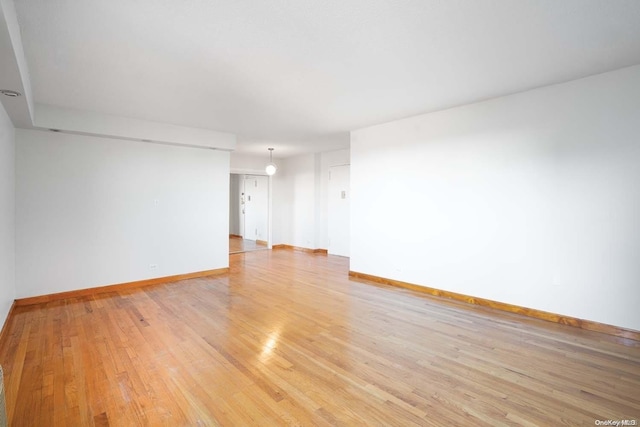 empty room with light hardwood / wood-style floors