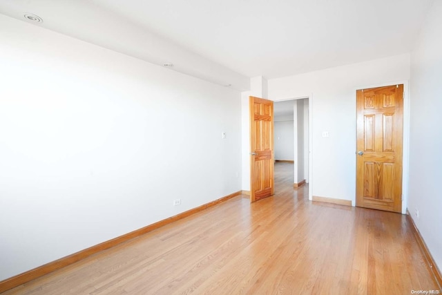 empty room with light hardwood / wood-style floors