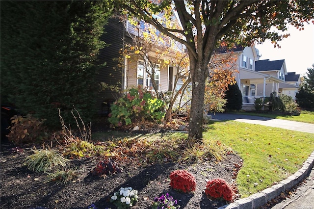 view of side of home with a yard