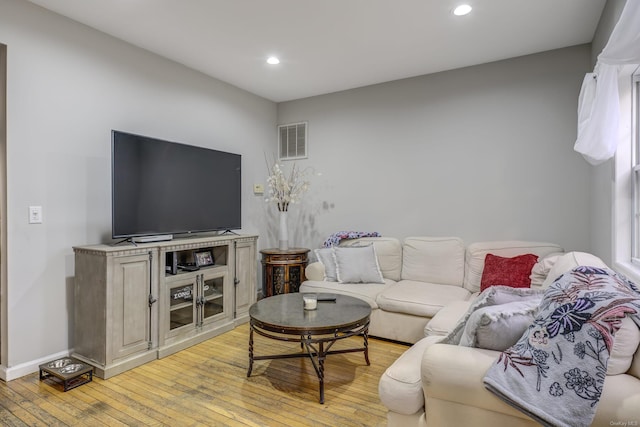 living room with light hardwood / wood-style flooring