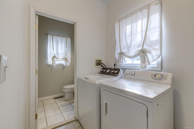 laundry room with light tile patterned flooring and independent washer and dryer