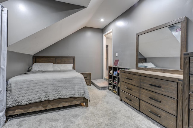 bedroom featuring vaulted ceiling and light carpet