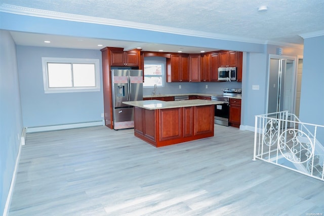 kitchen with a center island, light hardwood / wood-style floors, a baseboard heating unit, and appliances with stainless steel finishes