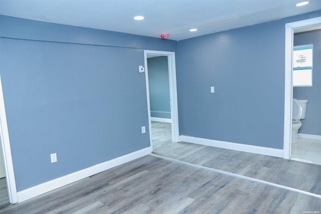 empty room with hardwood / wood-style floors