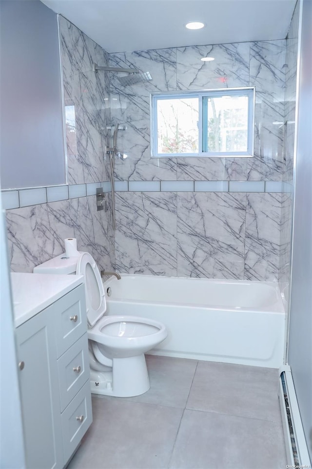 full bathroom with vanity, baseboard heating, tile walls, toilet, and tiled shower / bath