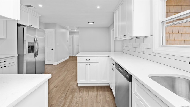 kitchen with light hardwood / wood-style flooring, white cabinets, stainless steel appliances, and sink