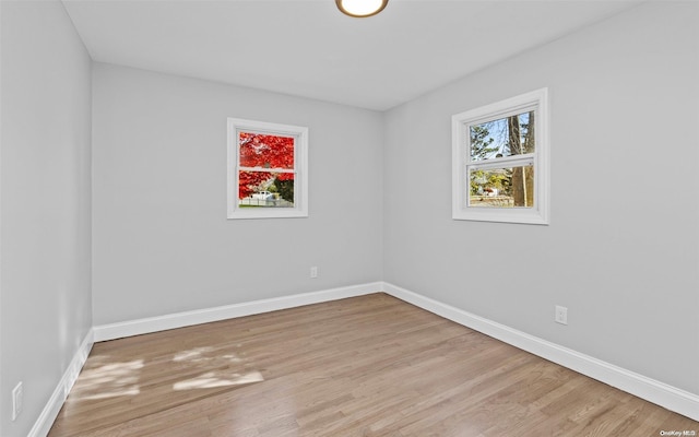 unfurnished room with light wood-type flooring