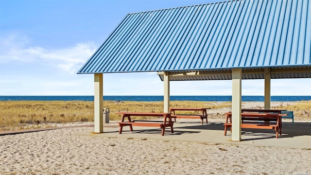 view of home's community with a water view and a view of the beach