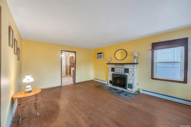 43 2nd St, Ronkonkoma, NY 11779 - unfurnished living room with hardwood / wood-style floors, baseboards, a baseboard radiator, and a fireplace