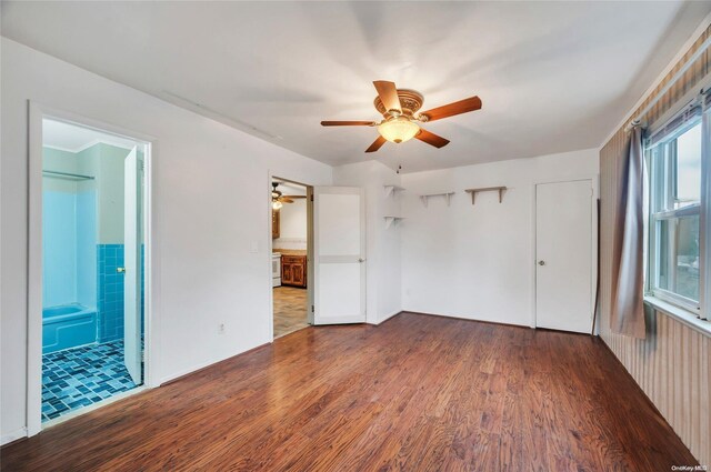43 2nd St, Ronkonkoma, NY 11779 - unfurnished bedroom with wood finished floors, ensuite bathroom, and a ceiling fan