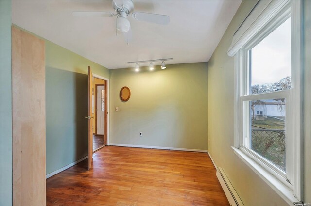 43 2nd St, Ronkonkoma, NY 11779 - unfurnished room with healthy amount of natural light, light wood-style flooring, and ceiling fan