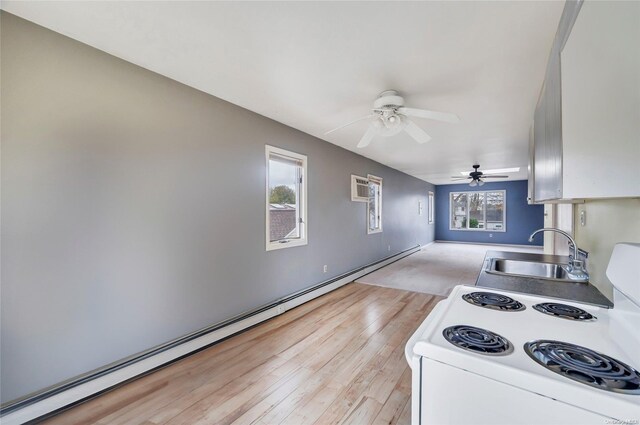 43 2nd St, Ronkonkoma, NY 11779 - kitchen featuring electric stove, baseboard heating, a sink, a ceiling fan, and light wood finished floors