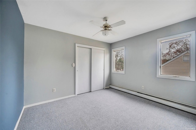 43 2nd St, Ronkonkoma, NY 11779 - unfurnished bedroom with a baseboard heating unit, carpet flooring, a closet, and baseboards