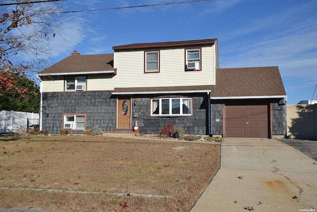 front of property with a garage and a front lawn