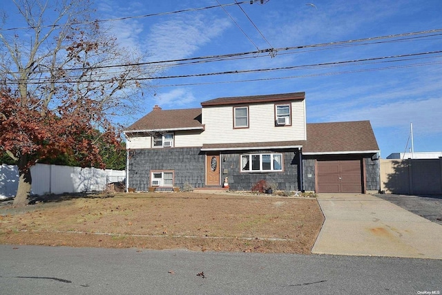 front of property with a front lawn and a garage