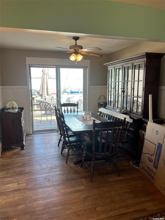 dining area featuring ceiling fan and dark wood-type flooring