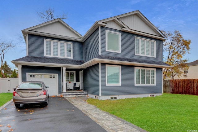 view of front of home with a garage and a front lawn