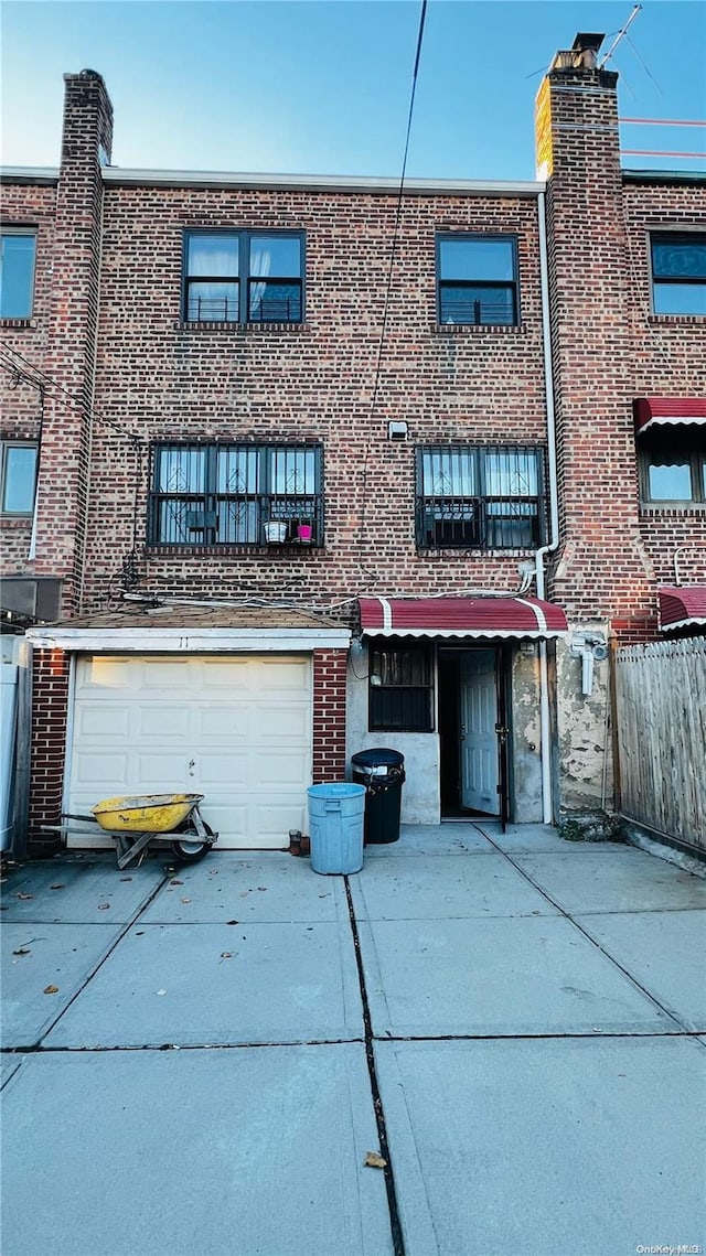 rear view of house featuring a garage