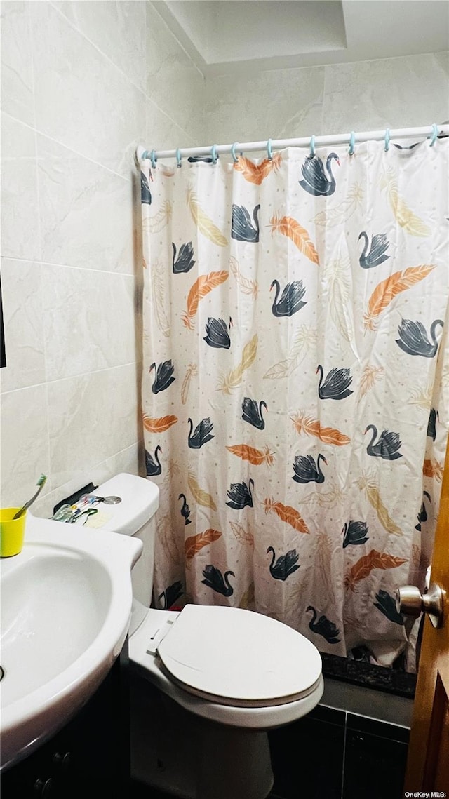 bathroom featuring sink, tile patterned flooring, toilet, tile walls, and a shower with shower curtain