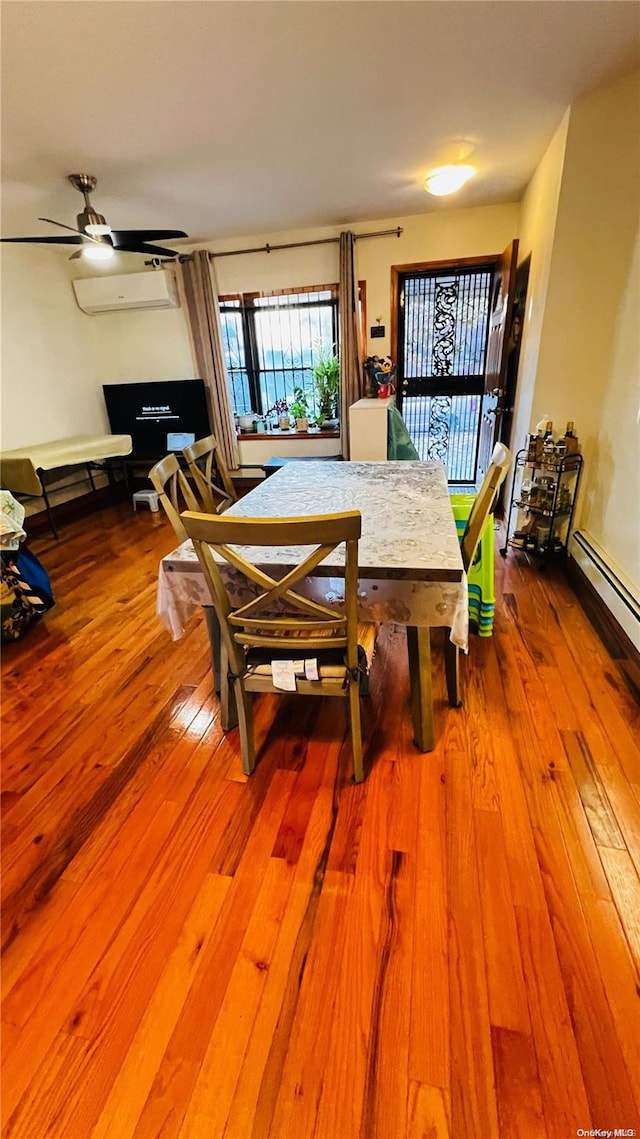 dining space with hardwood / wood-style floors, a wall mounted AC, and ceiling fan