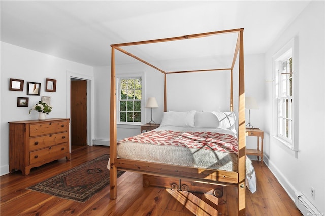 bedroom featuring hardwood / wood-style floors and a baseboard radiator