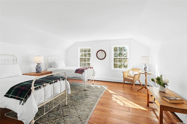 bedroom featuring lofted ceiling and hardwood / wood-style flooring