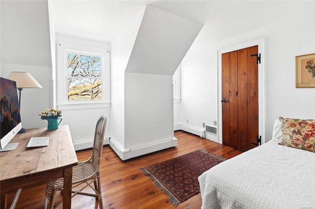 bedroom featuring hardwood / wood-style flooring, vaulted ceiling, and baseboard heating