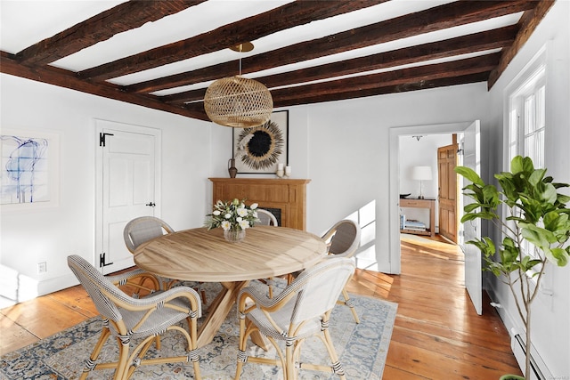 1117 Cedar Ln, East Marion, NY 11939 - dining space with beam ceiling, light wood-style flooring, and a fireplace