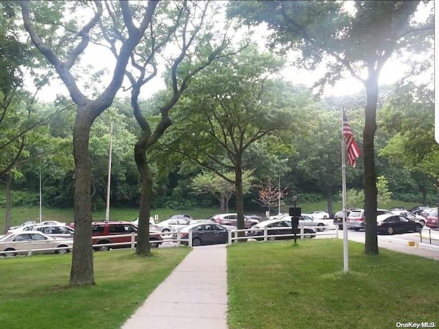 83-85 Woodhaven Blvd Unit 1K, Woodhaven, NY 11421 - view of property's community with uncovered parking and a lawn