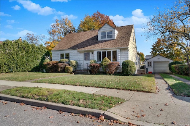 new england style home with a garage, an outdoor structure, and a front lawn