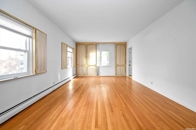 spare room featuring light hardwood / wood-style flooring and a baseboard heating unit