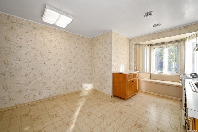 interior space featuring vanity and a tub to relax in