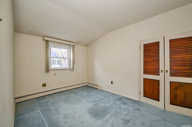 empty room with french doors, carpet floors, baseboard heating, and lofted ceiling