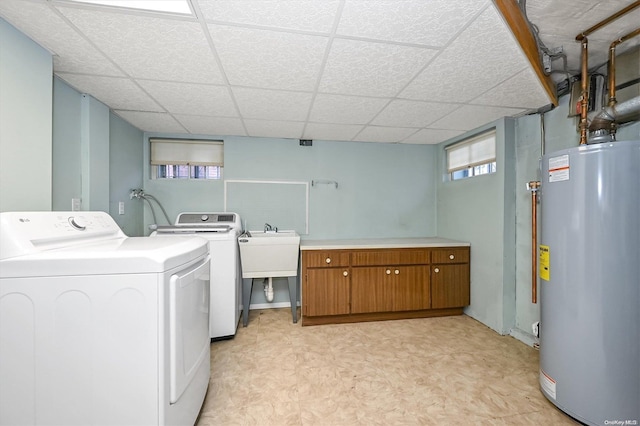 clothes washing area featuring washer and clothes dryer and water heater