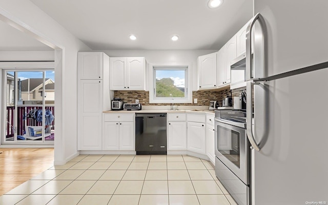 kitchen featuring white cabinets, decorative backsplash, light wood-type flooring, and stainless steel appliances