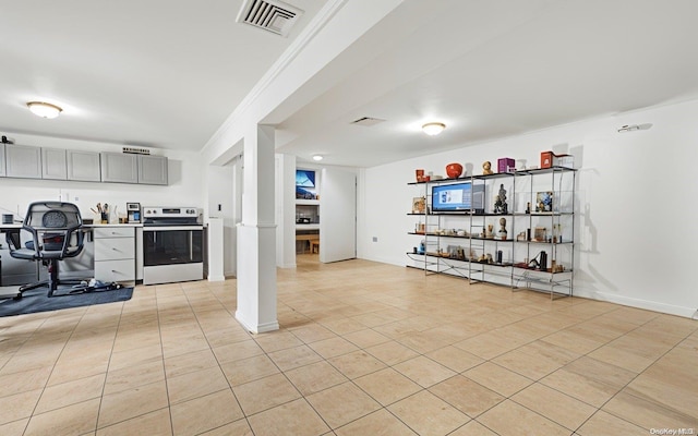 kitchen with light tile patterned floors, gray cabinets, crown molding, and stainless steel electric range