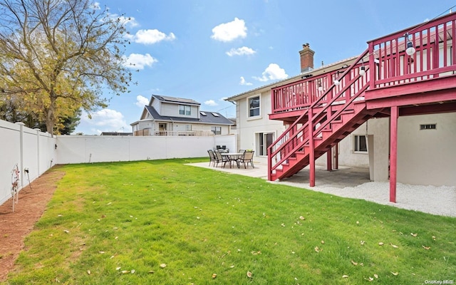 view of yard with a deck and a patio