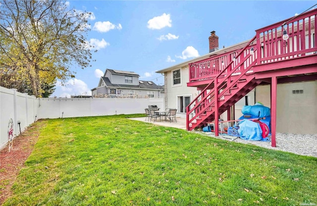 view of yard with a patio area and a wooden deck