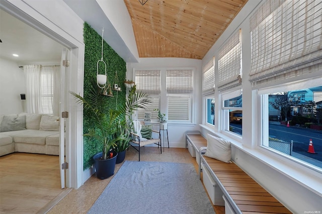 sunroom with plenty of natural light, wooden ceiling, and lofted ceiling