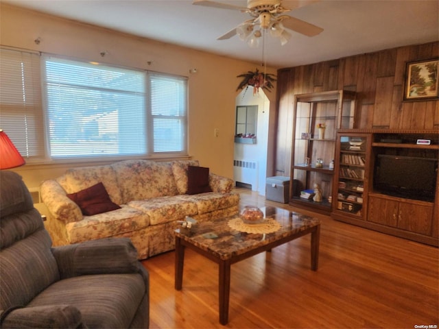 living room with radiator, ceiling fan, and wood finished floors