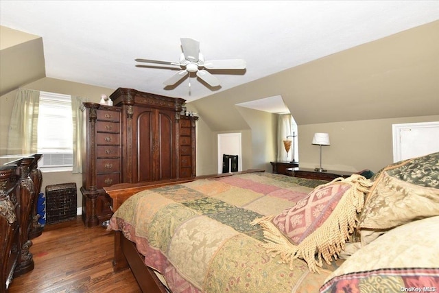 bedroom featuring ceiling fan, dark wood-type flooring, and vaulted ceiling