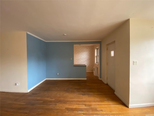 unfurnished room with hardwood / wood-style flooring and crown molding