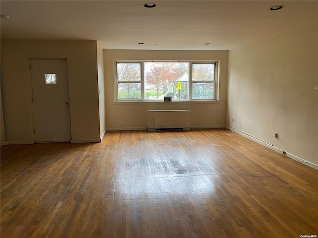 entrance foyer with hardwood / wood-style flooring and radiator