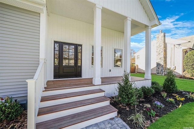 view of exterior entry with covered porch