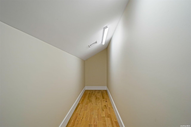 bonus room featuring light hardwood / wood-style flooring and lofted ceiling