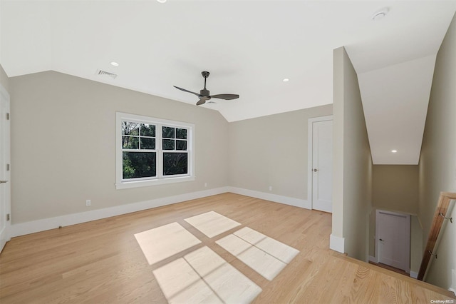 spare room featuring ceiling fan, light hardwood / wood-style floors, and vaulted ceiling