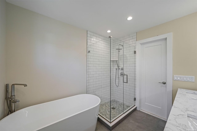 bathroom with vanity and independent shower and bath