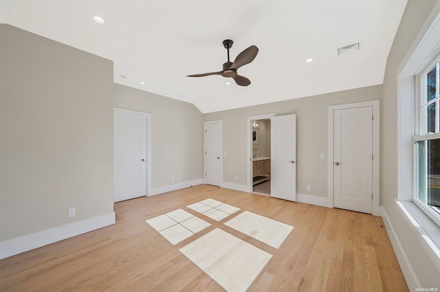 unfurnished bedroom featuring ceiling fan, light wood-type flooring, and connected bathroom