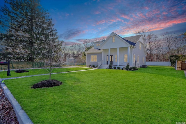 view of front facade featuring a yard and covered porch